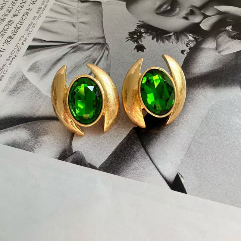 Gold-tone oval crystal stud earrings with vibrant green faceted stones