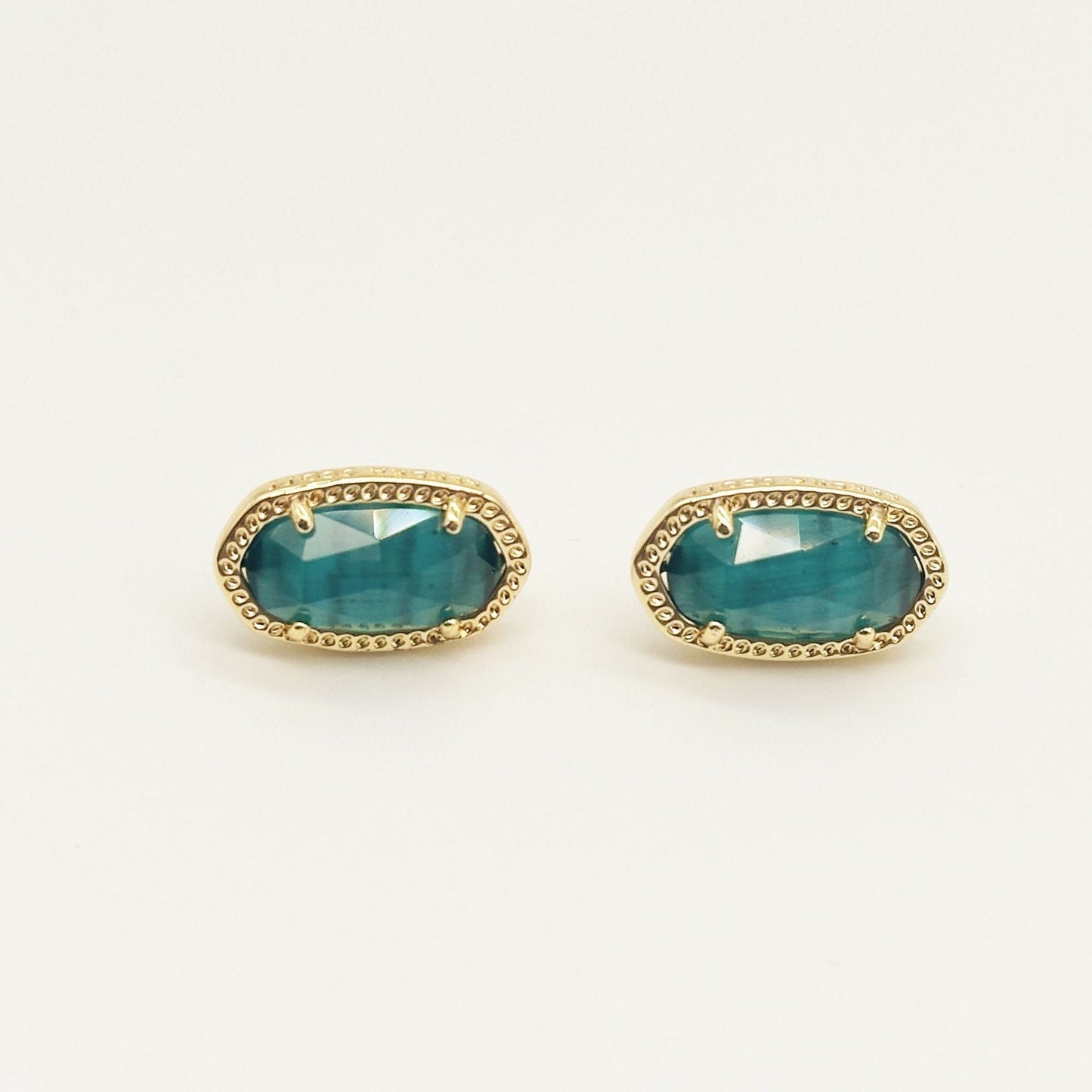 Kendra Scott oval gemstone stud earrings with teal crystal in gold bezel setting