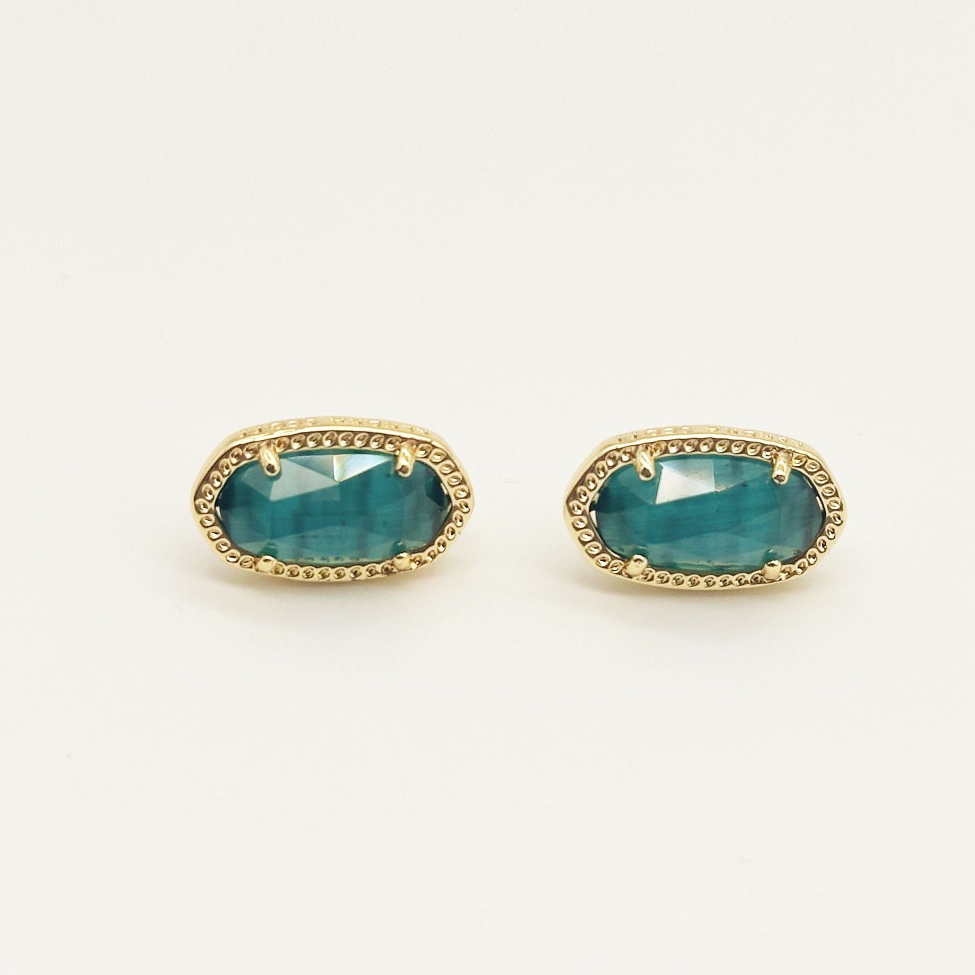 Kendra Scott oval gemstone stud earrings with teal crystal in gold bezel setting
