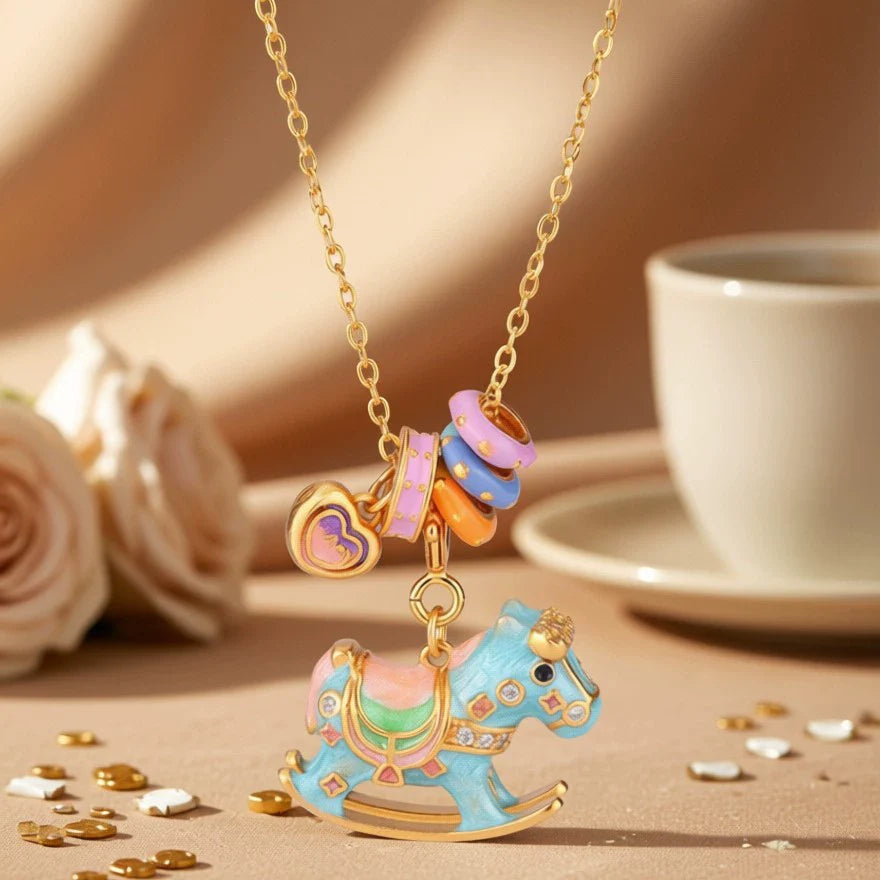 Enamel rocking horse pendant necklace with blue horse and pastel saddle charms on gold chain