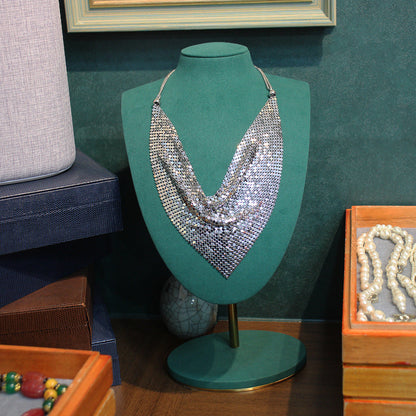 Silver sequin V-shaped statement necklace on bust display with layered texture