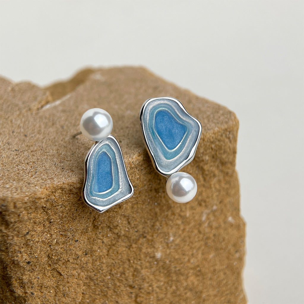 Asymmetric blue enamel drop earrings with white pearls on silver-tone settings