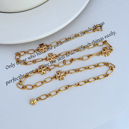 Gold-tone chain bracelets with clover logo link charms and round clasp
