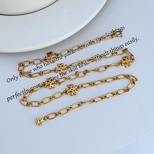 Gold-tone chain bracelets with clover logo link charms and round clasp