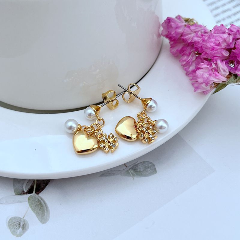 Gold-tone rhinestone heart earrings with clustered charms and white pearl dangles