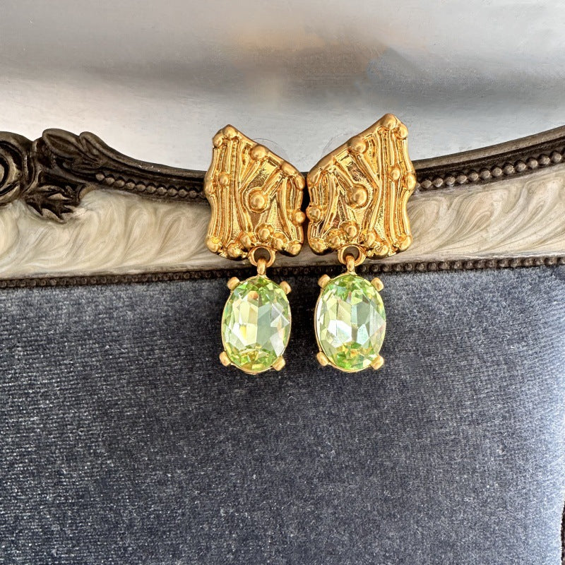 Gold-tone crystal drop earrings with oval green stones