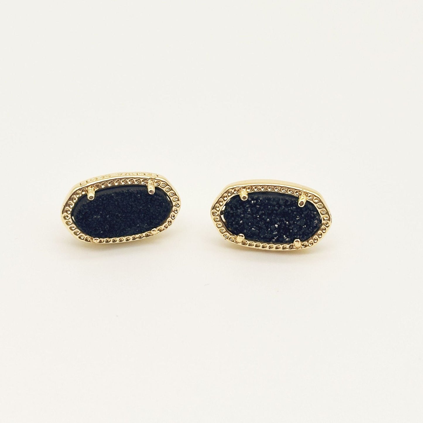 Kendra Scott oval gemstone stud earrings with dark blue crystal in gold bezel setting