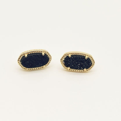 Kendra Scott oval gemstone stud earrings with dark blue crystal in gold bezel setting