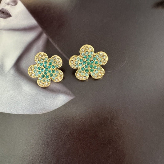 Gold-tone floral stud earrings with teal and clear rhinestones