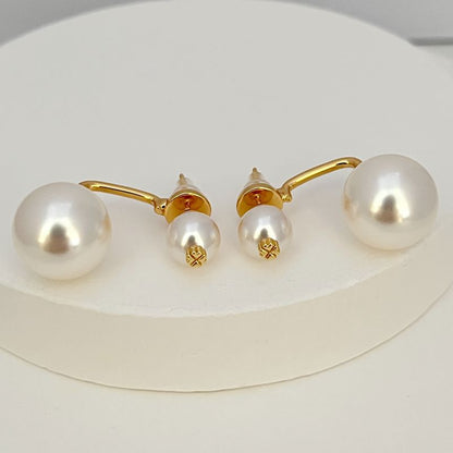 Gold-tone pearl earrings with large and small white pearls on hook