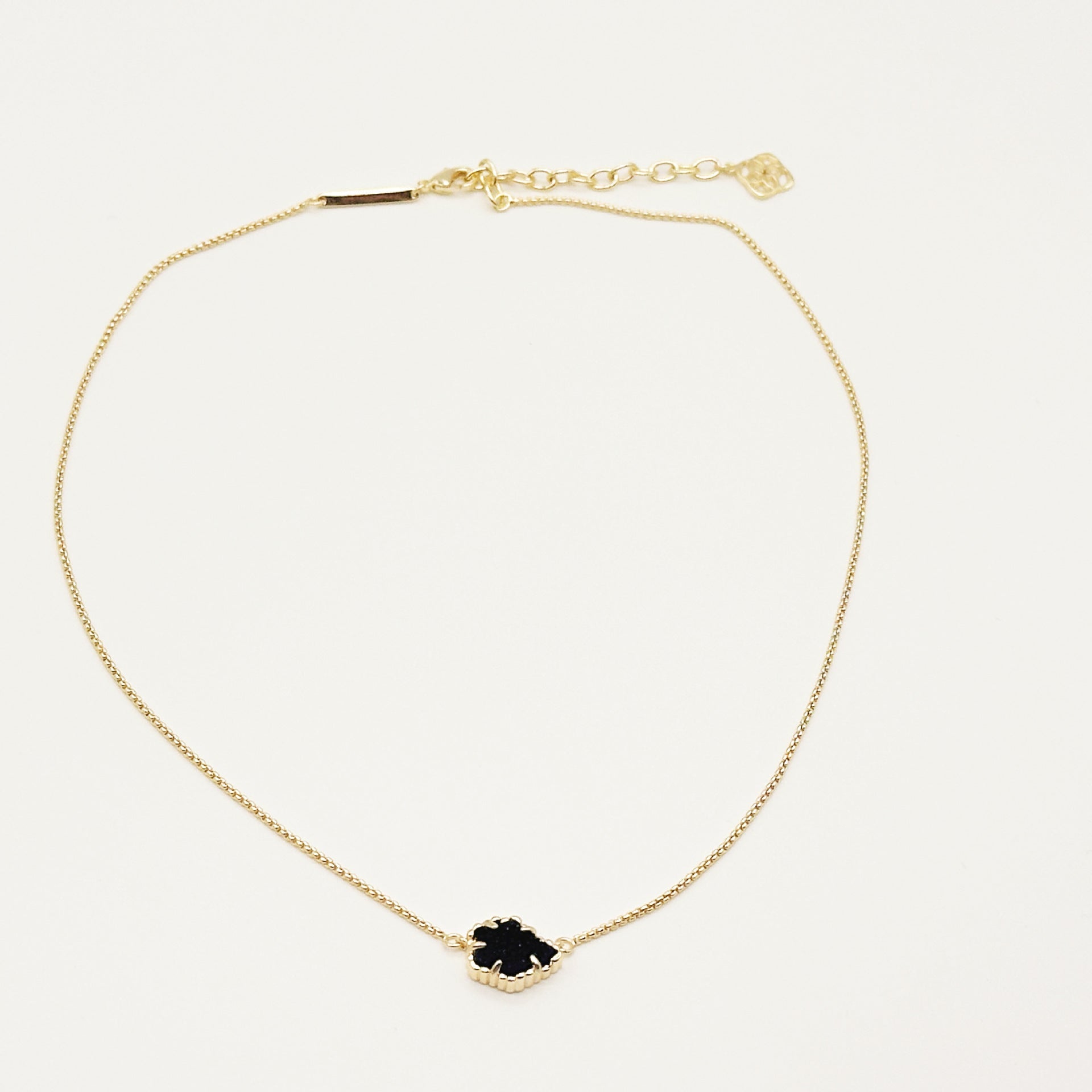 Kendra Scott gold-tone mother-of-pearl necklace with dark navy rhombus pendant