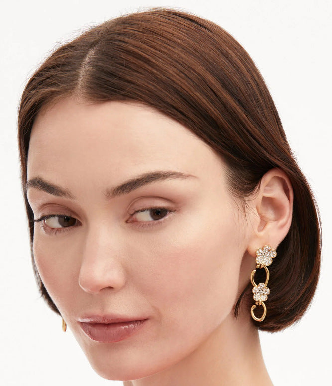 Floral dangle hoop earrings with gold-tone hoops and pink crystal flower clusters