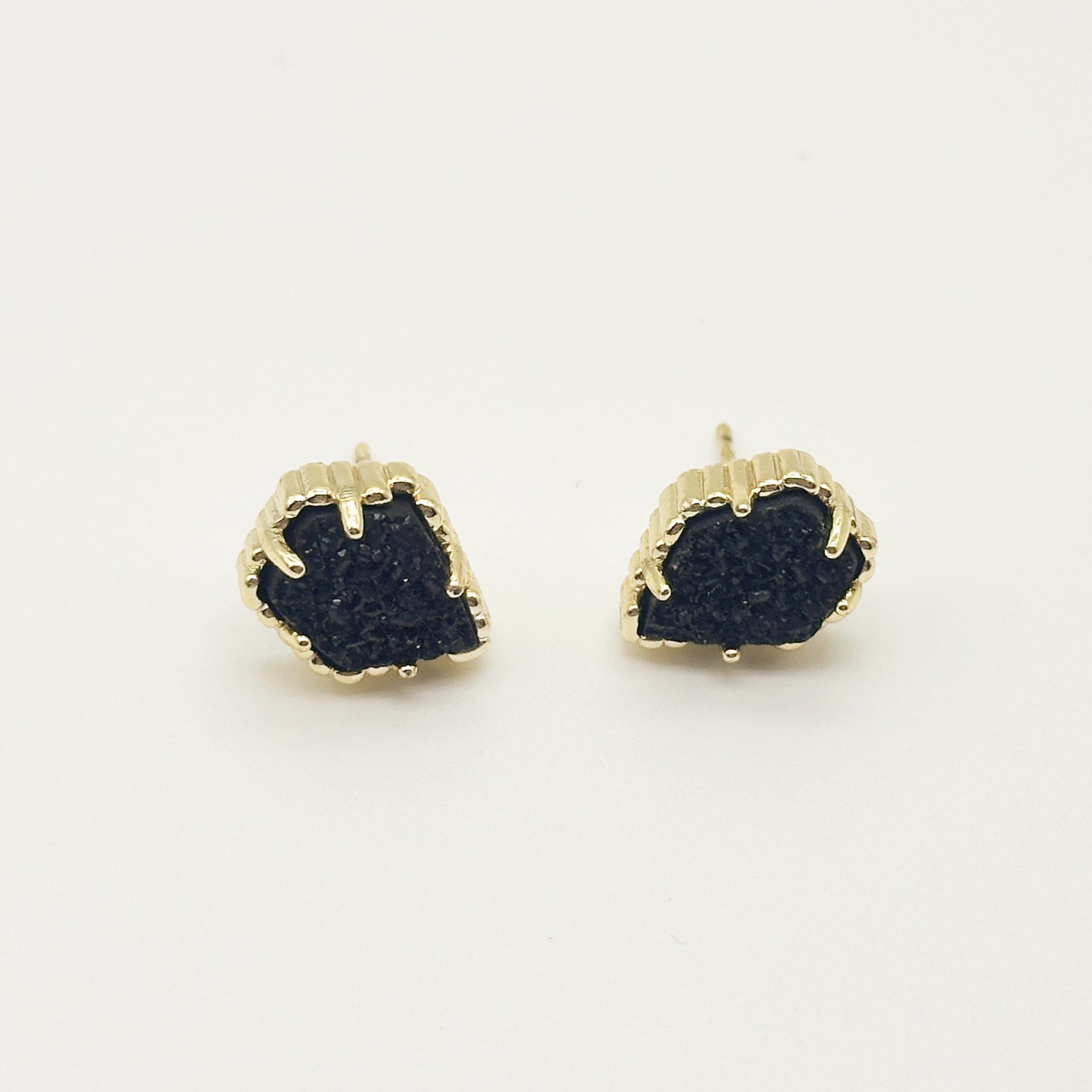 Pair of irregular rhombus stud earrings with dark stone and gold-tone scalloped bezel