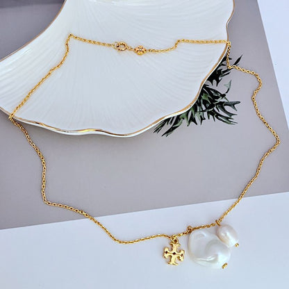 Gold metal necklace with baroque pearl pendants and small logo charm, adjustable chain