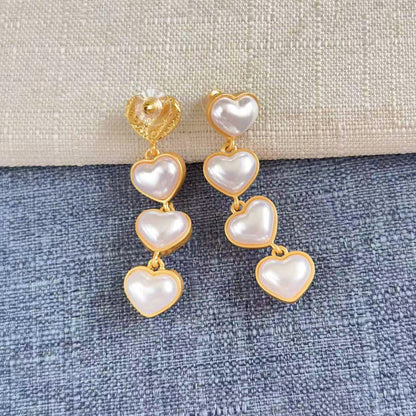 Heart-shaped long drop earrings with white hearts and pearl stud top, gold-tone links