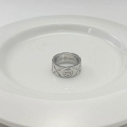 Silver-tone round logo metal ring with enamel pattern, engraved inner band