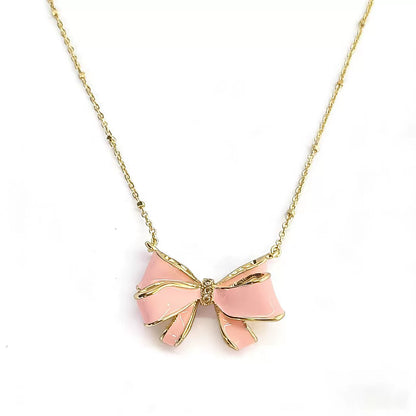 Gold bow pendant necklace with pink enamel ribbon and pearl drop center