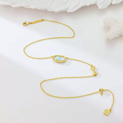 Gold butterfly pendant necklace set with oval blue charm and butterfly links