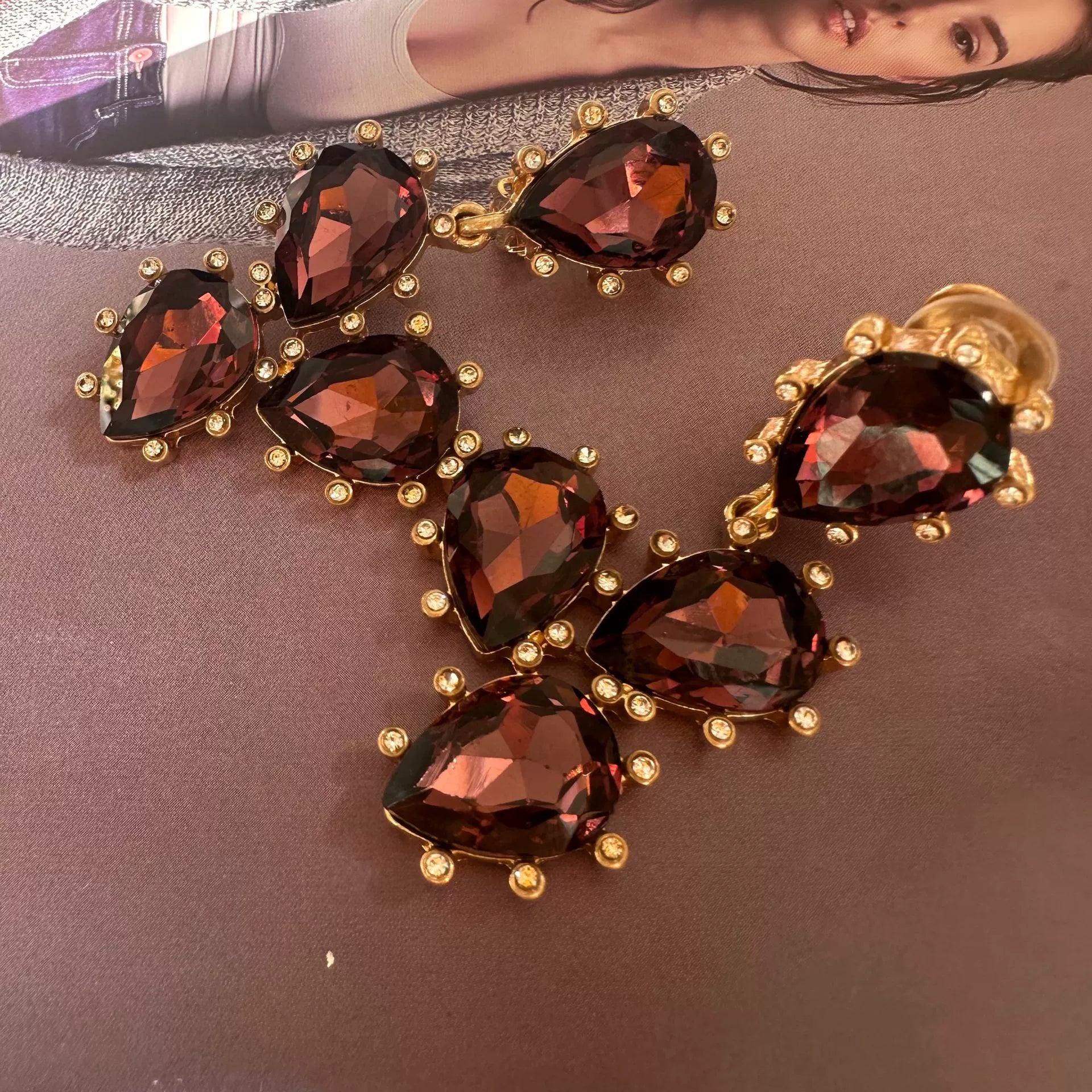 Cactus-cut glass ear clips with dark red stones and gold-tone prong setting