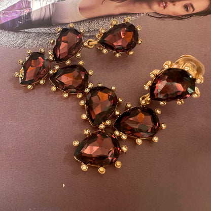 Cactus-cut glass ear clips with dark red stones and gold-tone prong setting