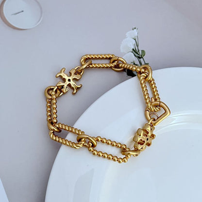 Gold square chunky chain logo bracelet with star-shaped emblem charm and clasp