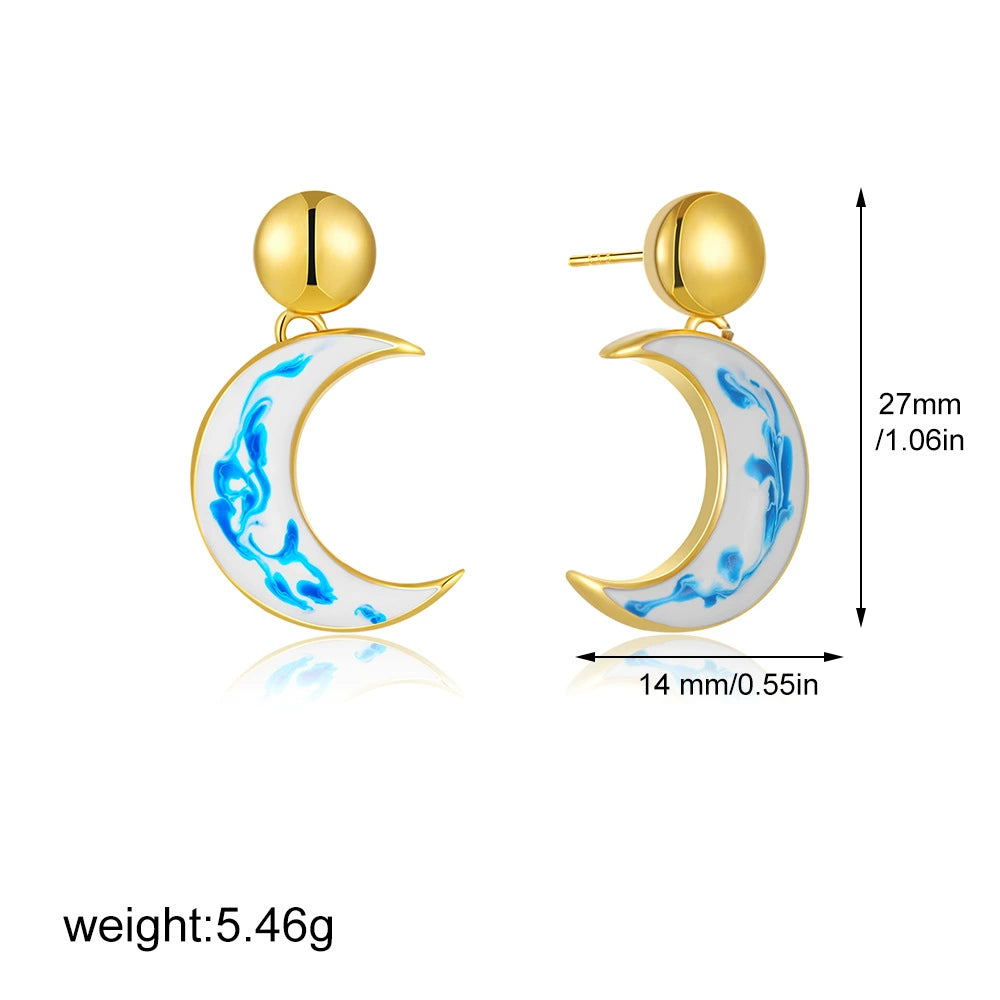 Gold-tone crescent moon statement earrings with blue marble swirl