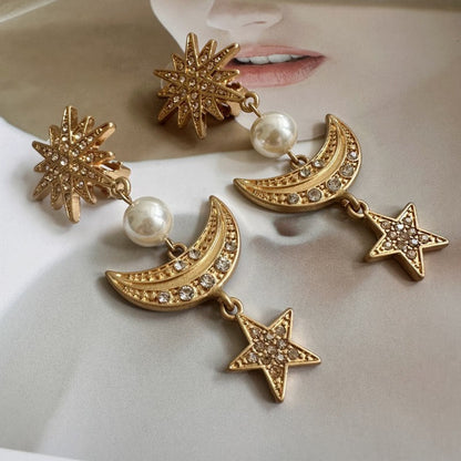 Gold star and moon drop earrings with pearl beads and crystal pavé star charms