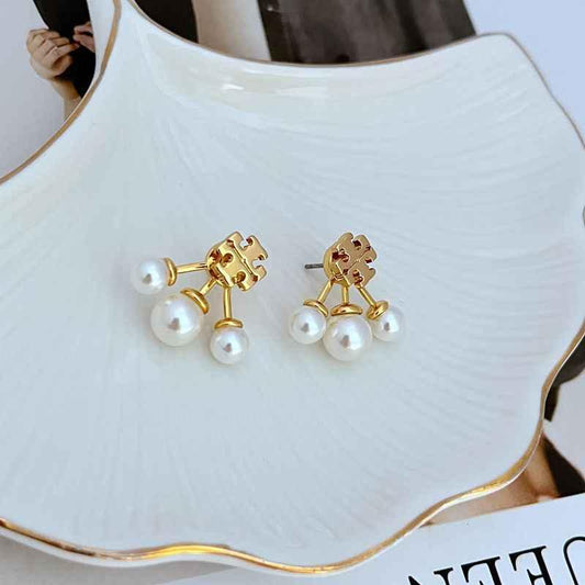 White pearl logo stud earrings with gold-tone detachable bead drops, three pearls each
