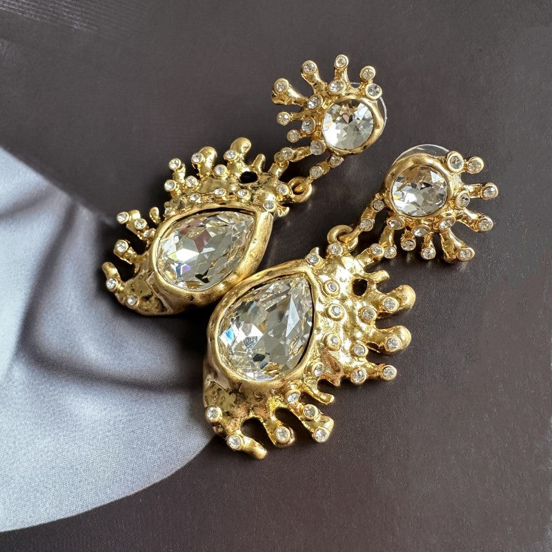Gold-tone cactus crystal dangle earrings with clear teardrop stones and spiky starburst mounts