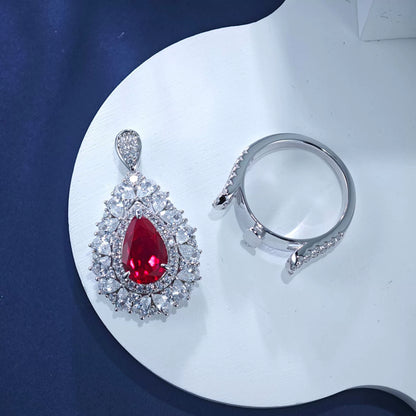 Sterling silver teardrop ruby ring and matching pendant necklace with diamond accents