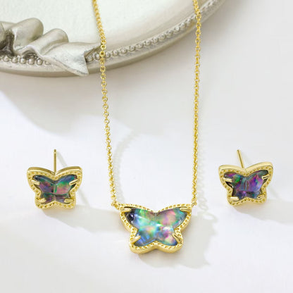 Gold butterfly necklace and stud earrings set with iridescent multi-color stones