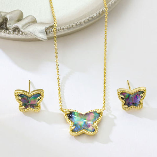 Gold butterfly necklace and stud earrings set with iridescent multi-color stones