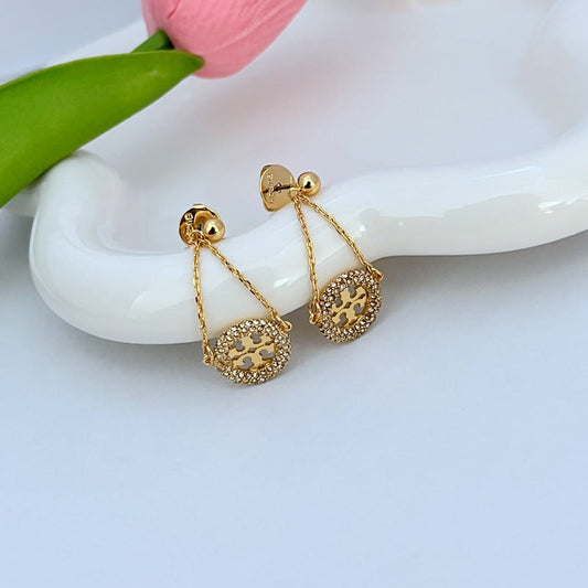 Gold hoop drop earrings with round pavé rhinestone charm and chain, stud back detail