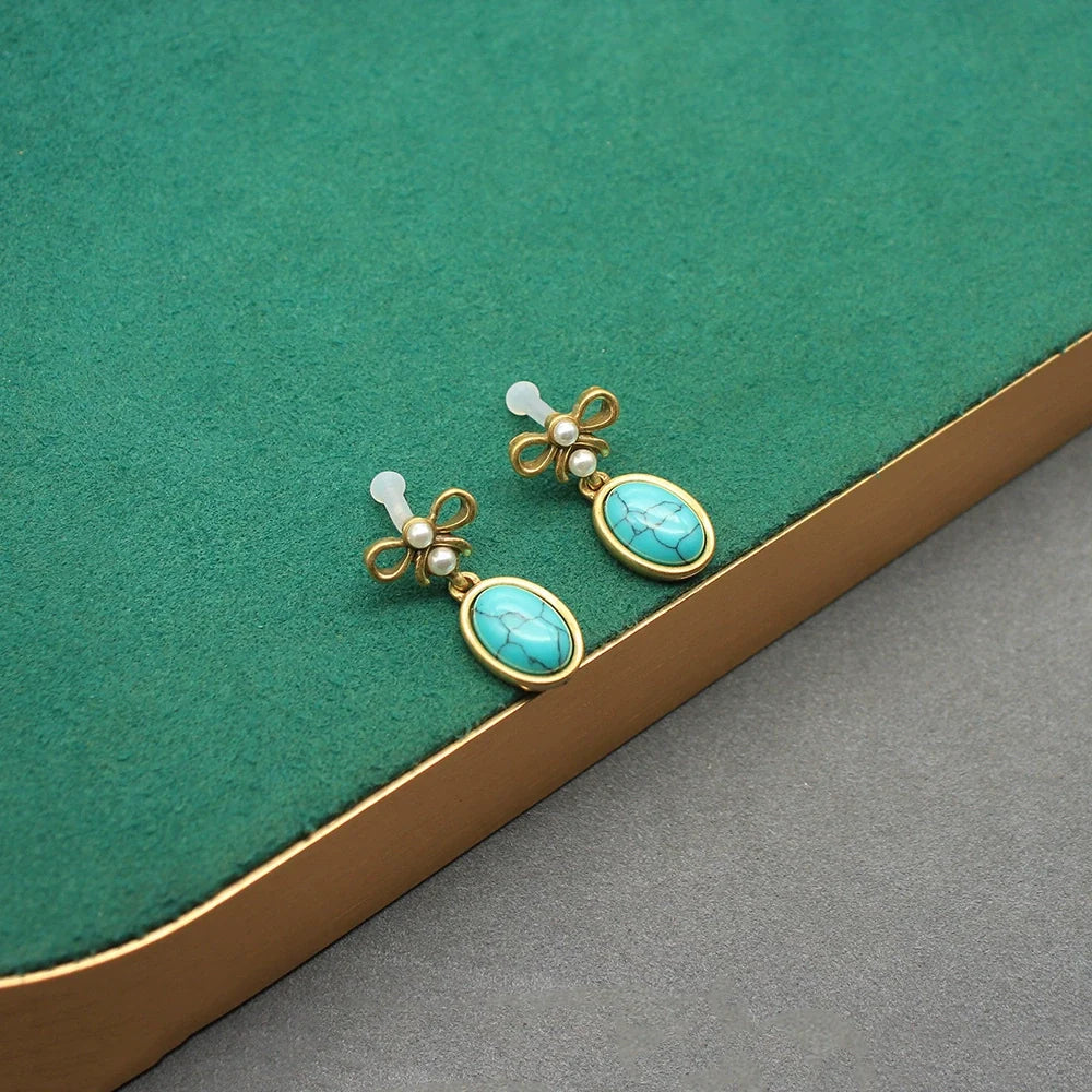 Vintage turquoise oval glass drop earrings with gold bow tops and pearl accents