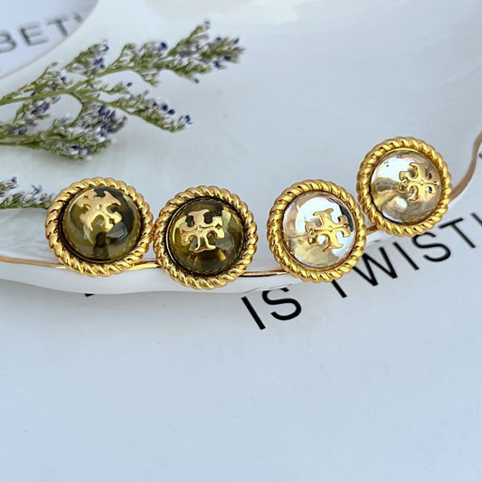 Set of round gold-tone stud earrings with logo medallion fronts, pair shown