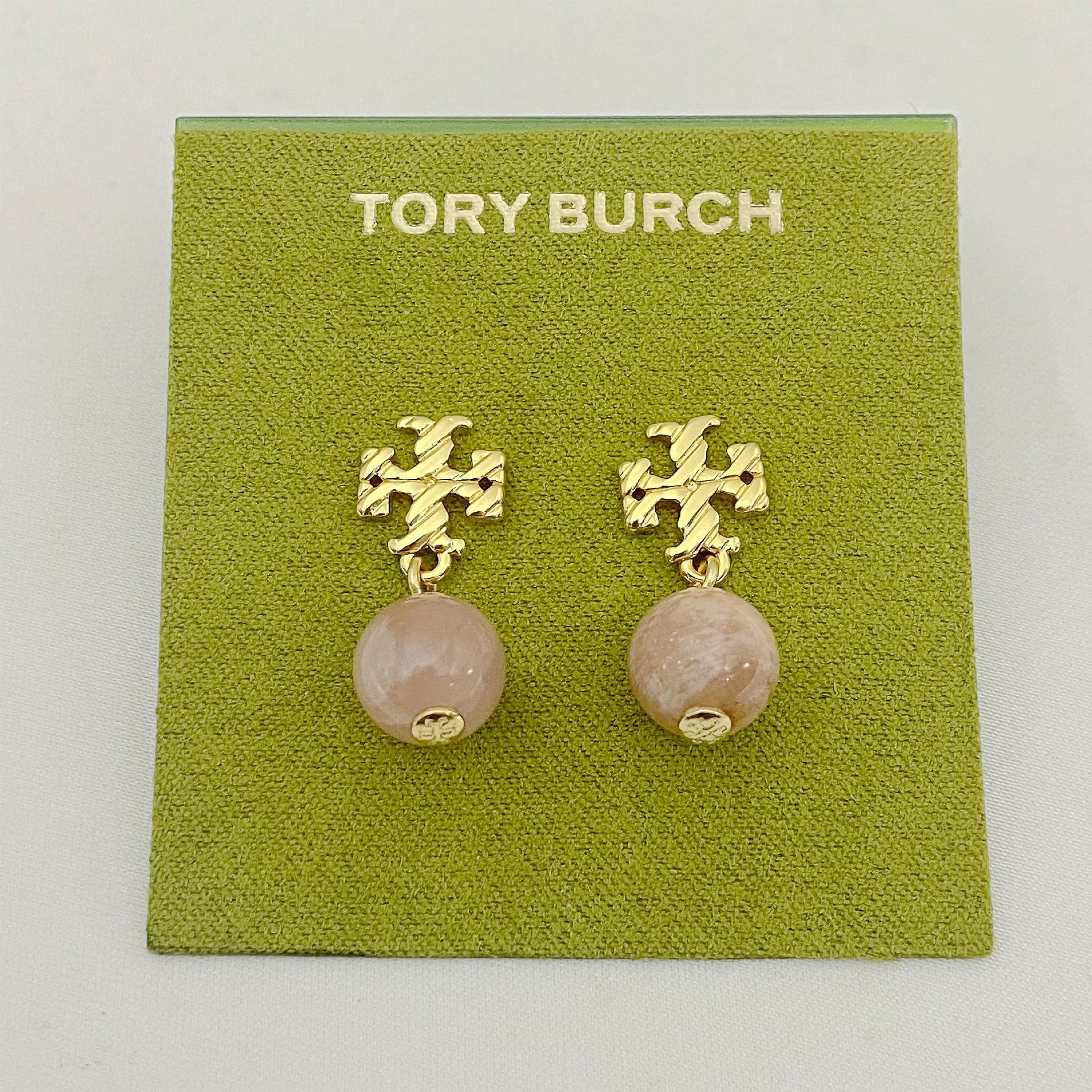 Gold-tone agate pendant earrings with round pale rose stones and leaf-like motif