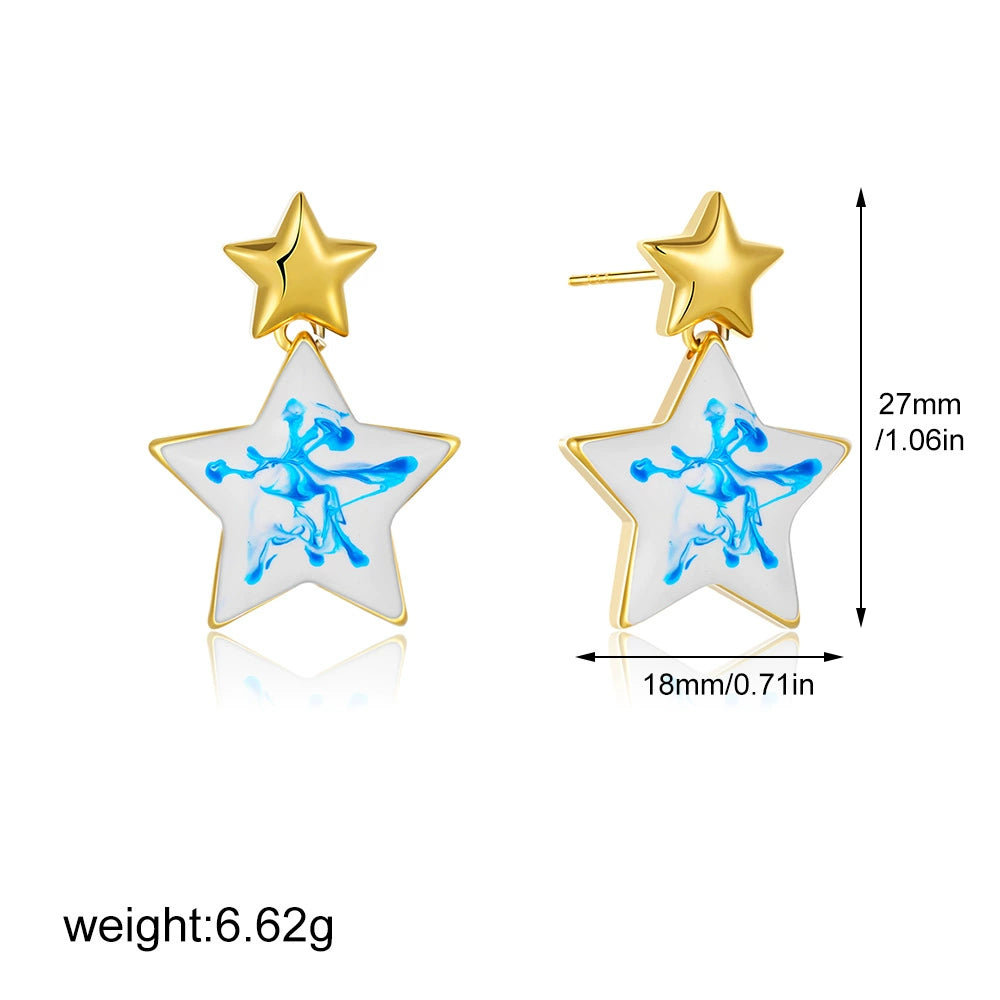 Gold-tone star statement earrings with blue marble swirl inlay