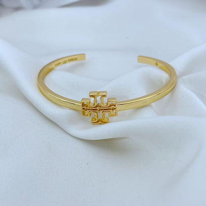 Openwork square logo smooth metal bangle, gold tone with central emblem detail
