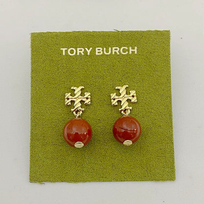 Gold-tone agate pendant earrings with round orange-red stones and leaf-like top