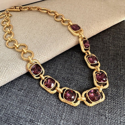 Gold-tone chain necklace with oval purple faceted crystals