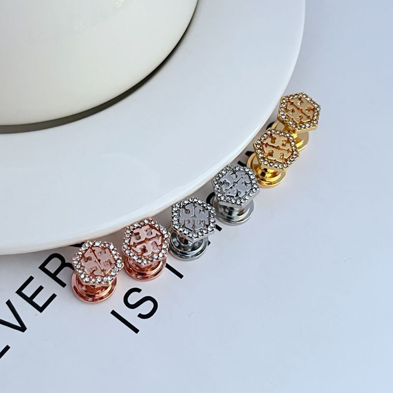 Hexagonal openwork metal stud earrings set in gold, rose gold, and white gold with gems