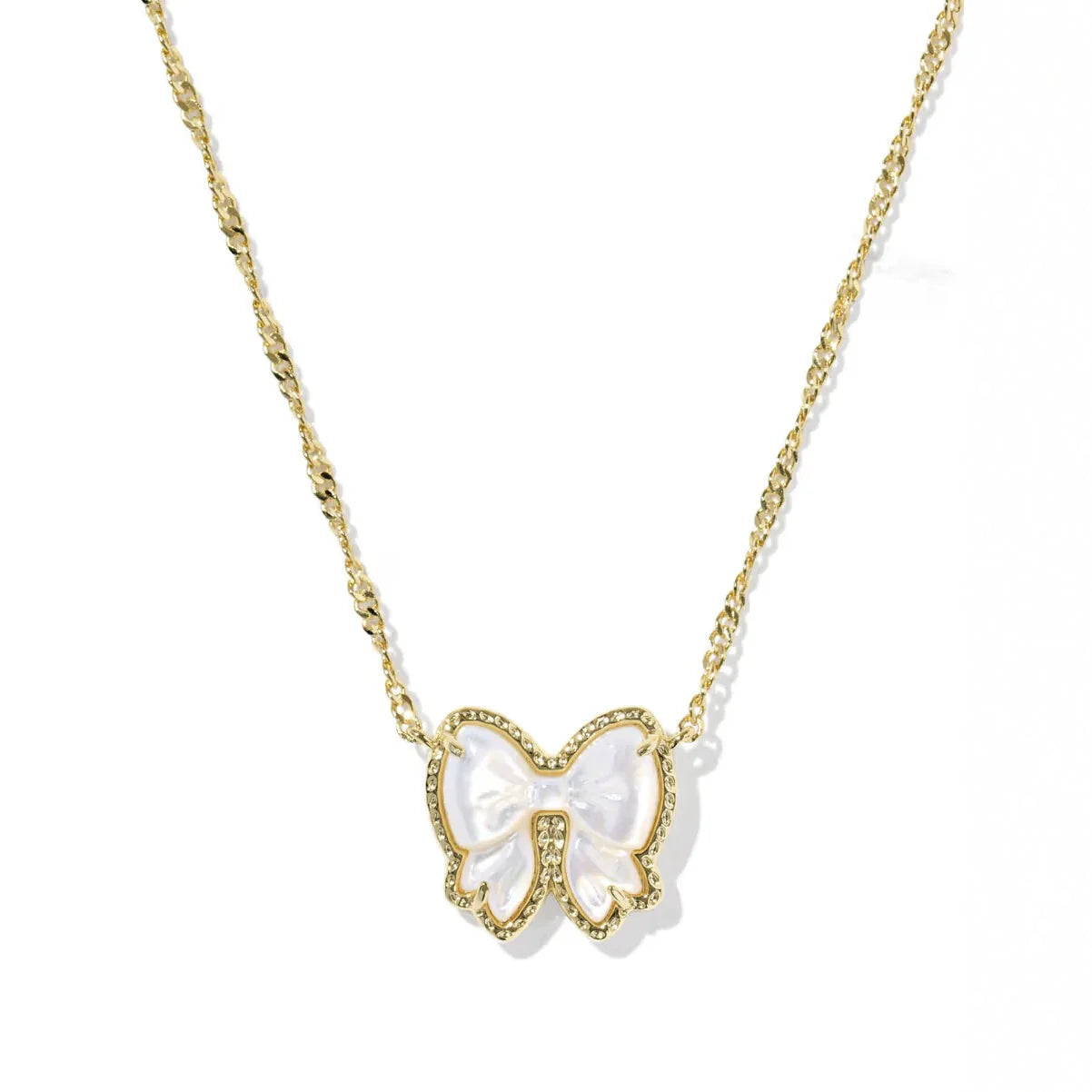 Gold-tone chain necklace with white bow pendant bordered with clear stones