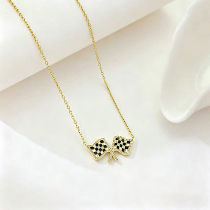 Gold chain necklace with checkered flag bow pendant at center