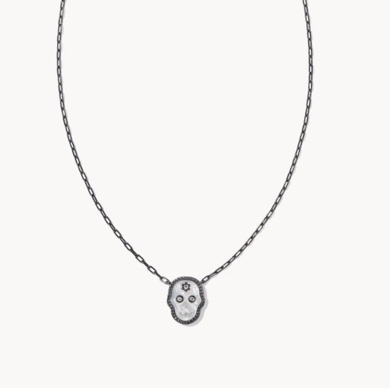 Dark-toned chain necklace with black skull pendant and white center