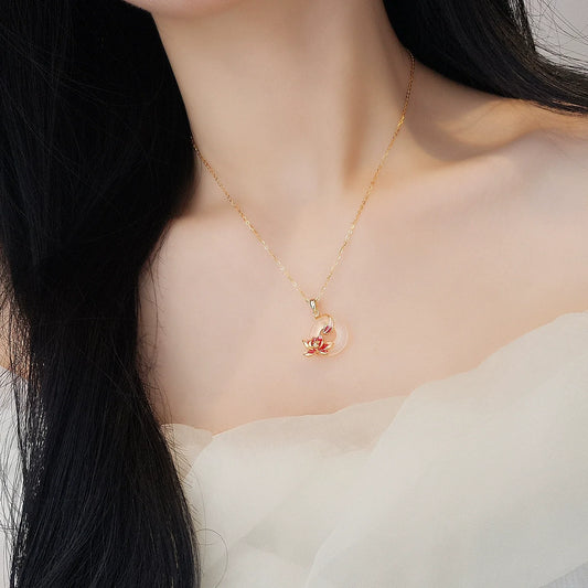 Gold-tone chain necklace with natural white chalcedony peace-knot flower pendant