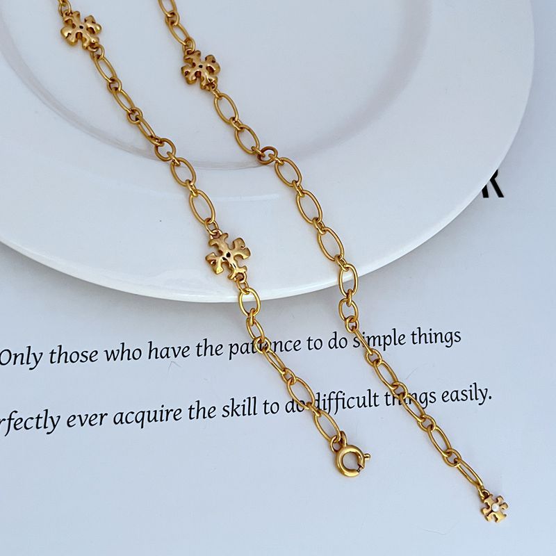 Gold-tone chain with clover logo links and loop clasp ends