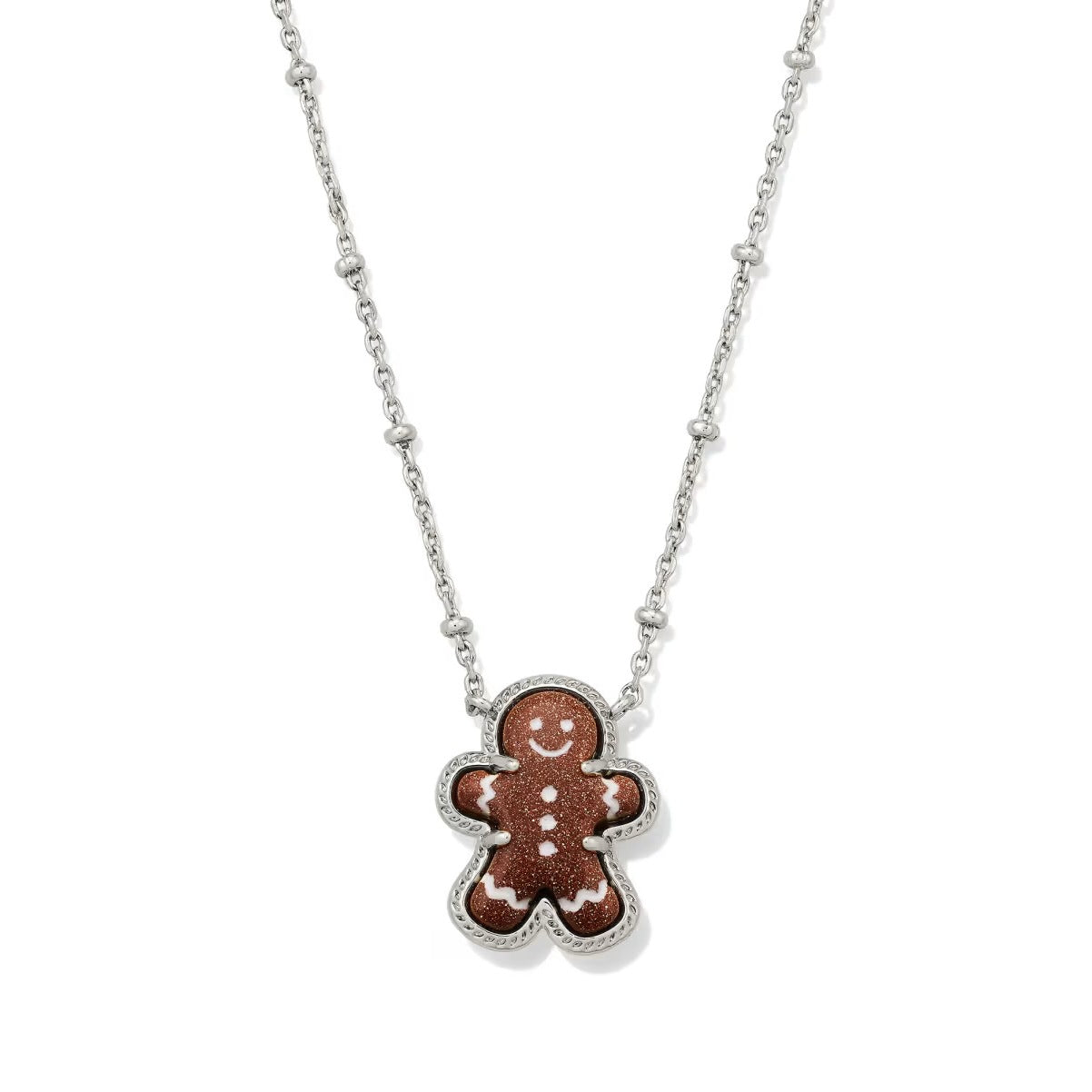 Silver gingerbread man pendant necklace with chain and enamel face details.
