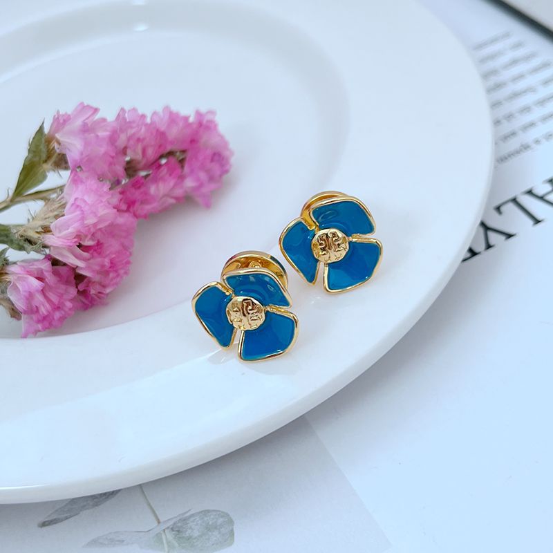 Tory Burch enamel camellia stud earrings with blue petals and gold-tone frames
