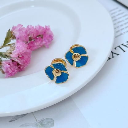 Tory Burch enamel camellia stud earrings with blue petals and gold-tone frames