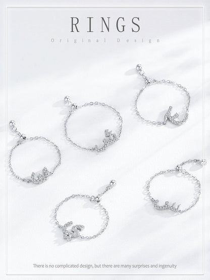 Assorted silver-tone adjustable chain rings with pavé Arabic letter charms